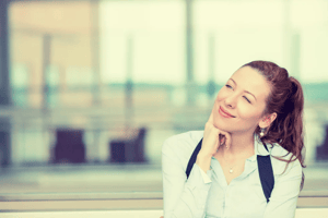 Portrait happy young woman thinking dreaming has many ideas looking up isolated office windows background. Positive human face expression emotion feeling reaction. Decision making process concept