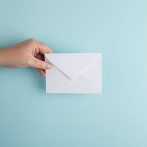 Newsletter Illustration - a hand holding an envelope