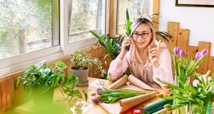 woman-florist-in-flower-shop-taking-order-by-mobil-2023-11-27-05-00-41-utc-Desktop-1